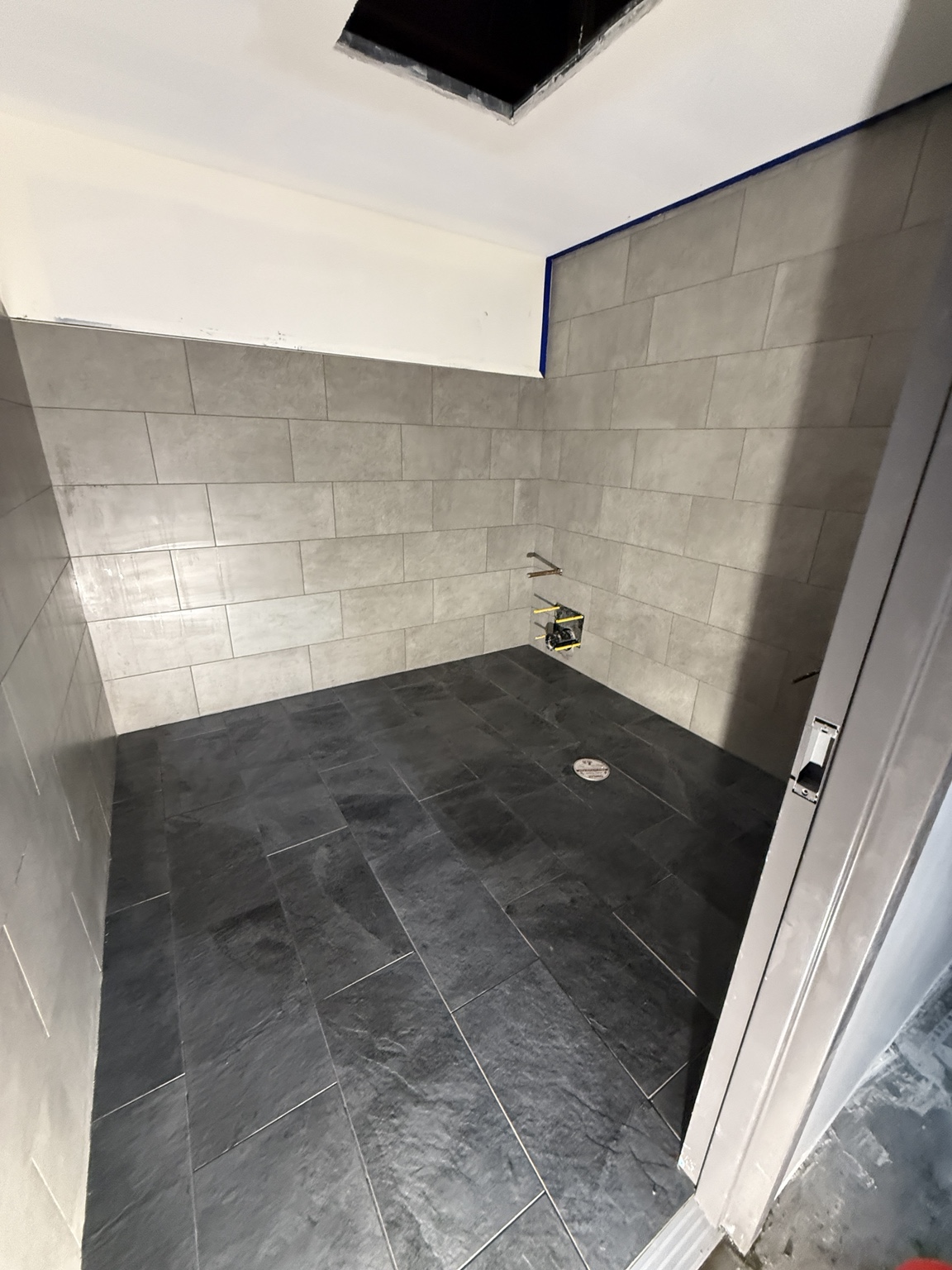 Light wall tile paired with dark floor tile