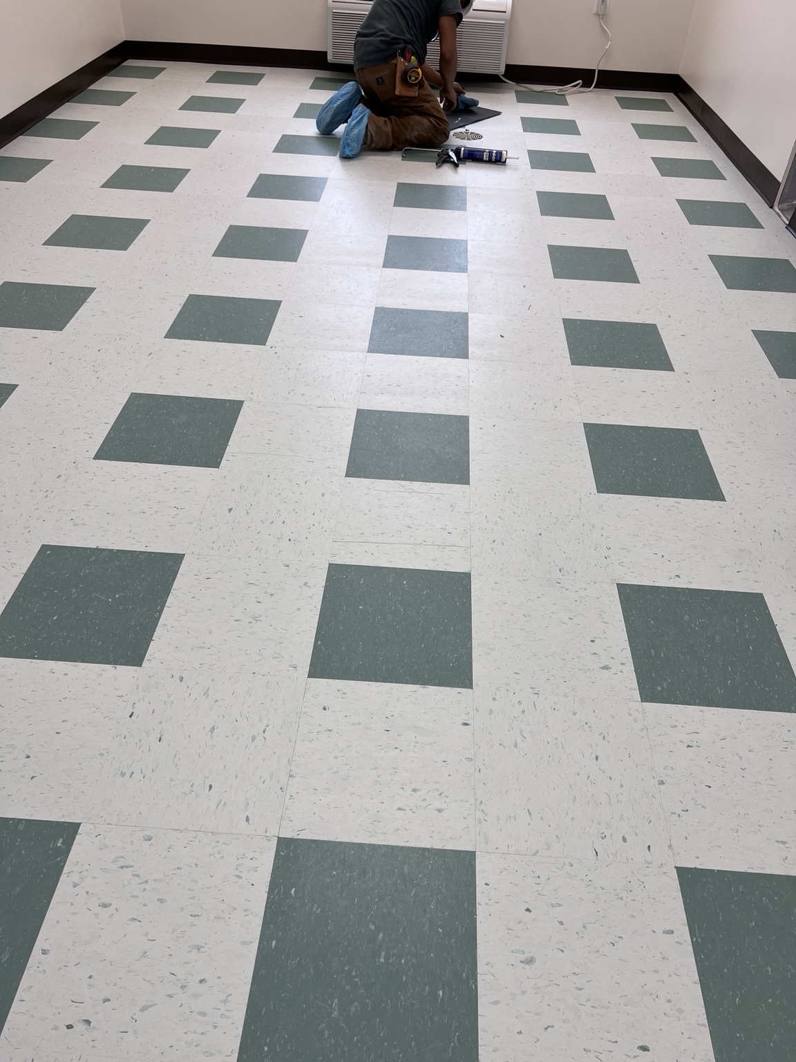 Patterned commercial flooring installation in progress