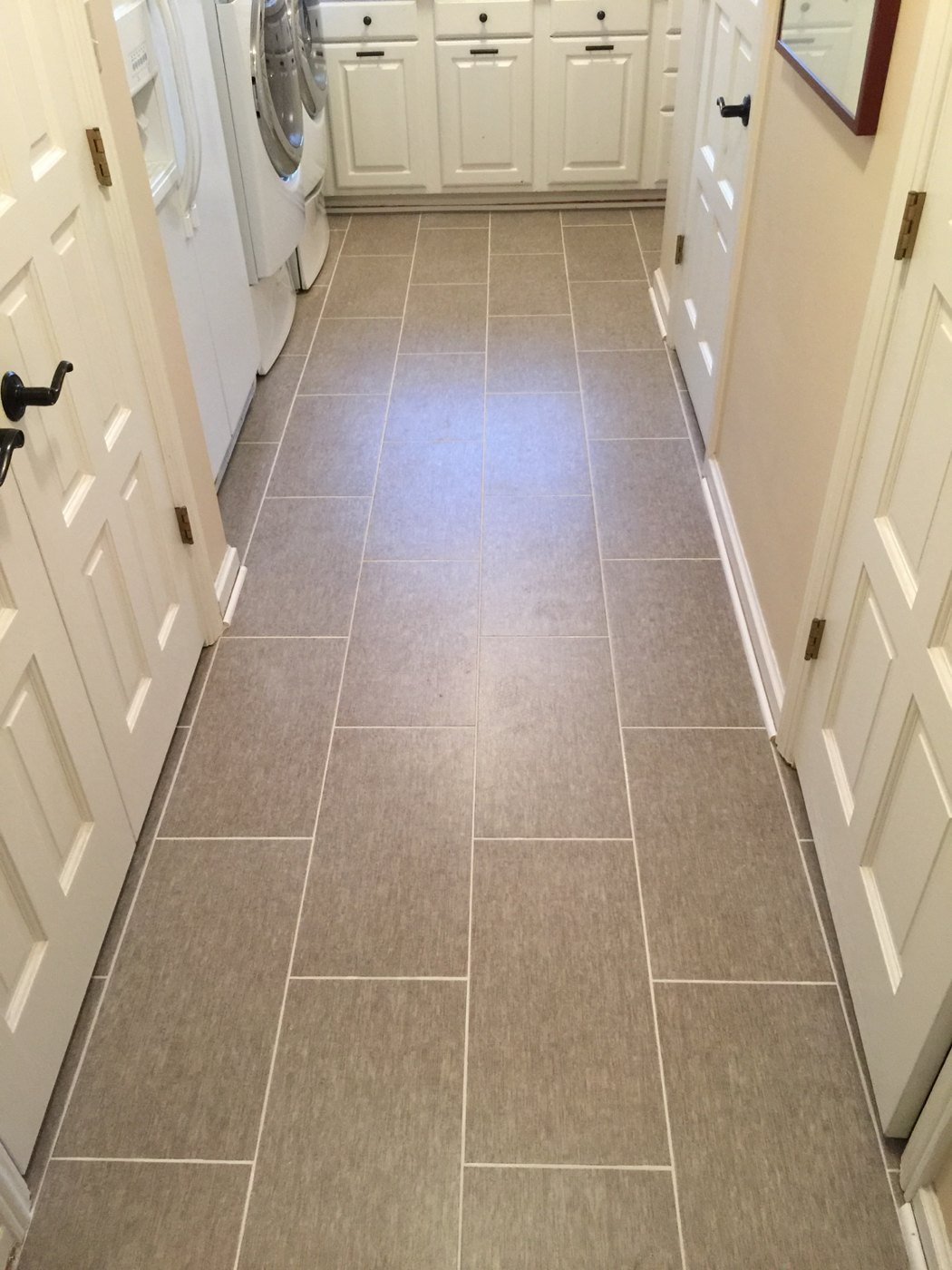 Gray staggered-pattern laundry room floor tile